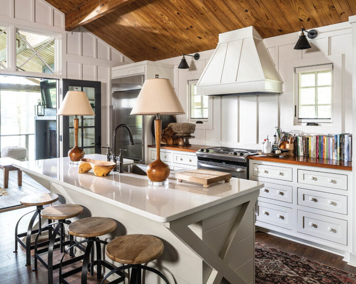 The open-concept living room and kitchen offer a warm welcome as soothing earth tones ground white walls and cabinets.