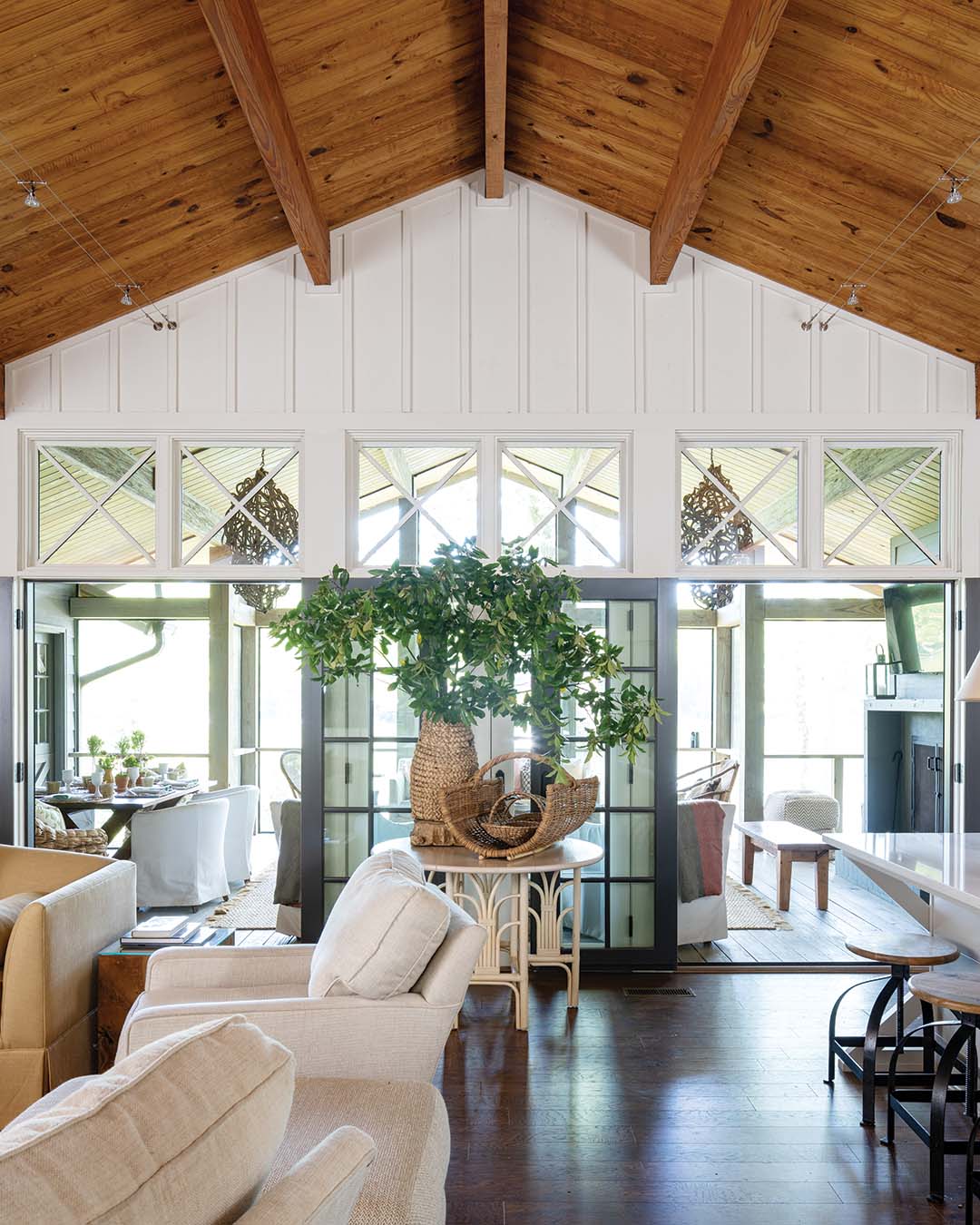 French doors direct attention to the expansive screened-in porch that houses an additional living space as well as an area for dining.