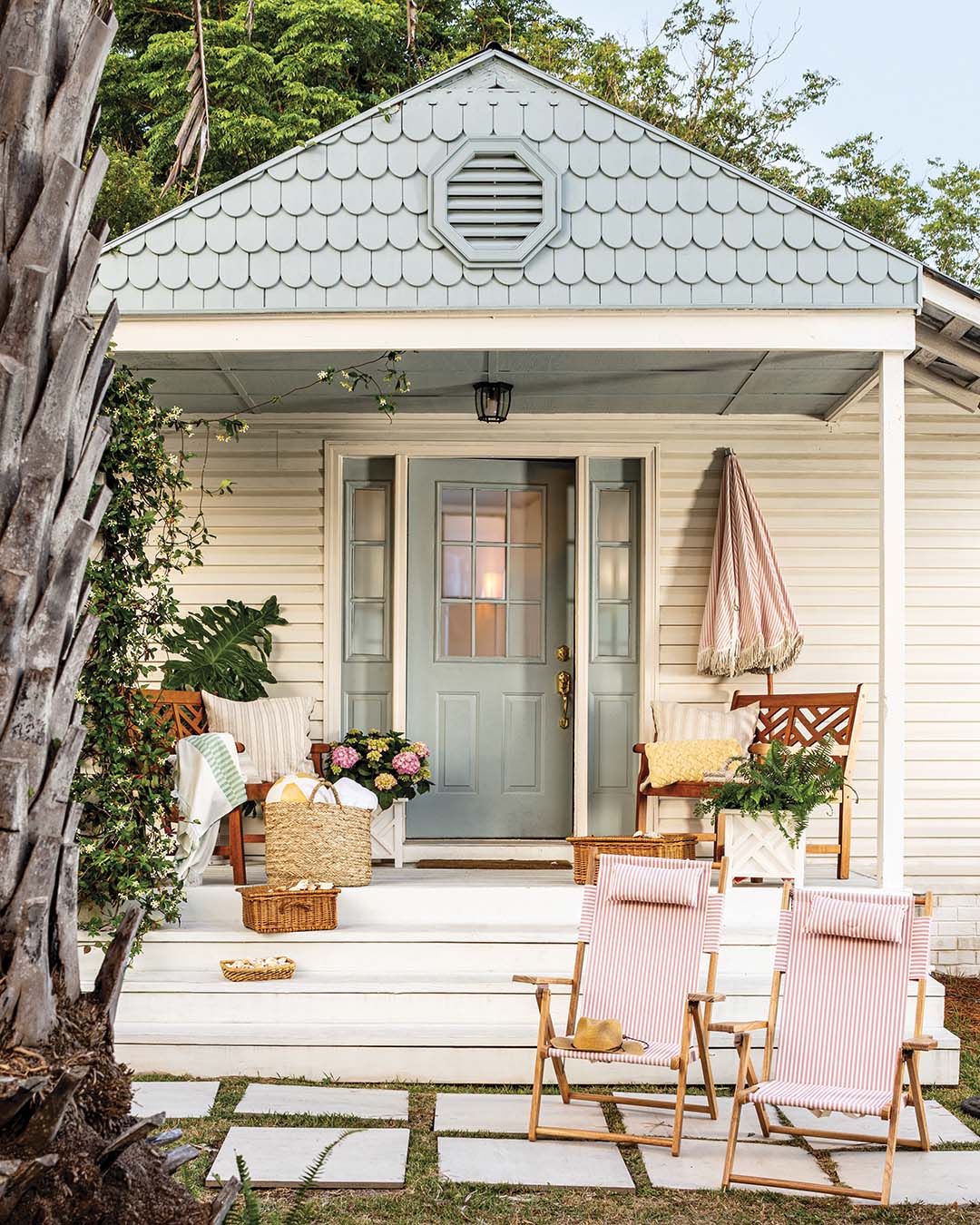 To maximize curb appeal, the Joneses reconfigured the porch so that stairs would lead up the front. The front door, ceiling, and scallop shingles were all painted a welcoming sky blue shade.