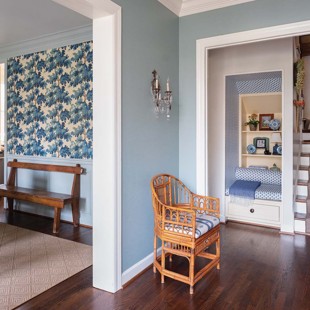 Entering through the front door, guests are greeted by a charming alcove addition. Anna took a blank wall and turned it into a reading nook that also provides smart storage with bookcases and a pull-out drawer.