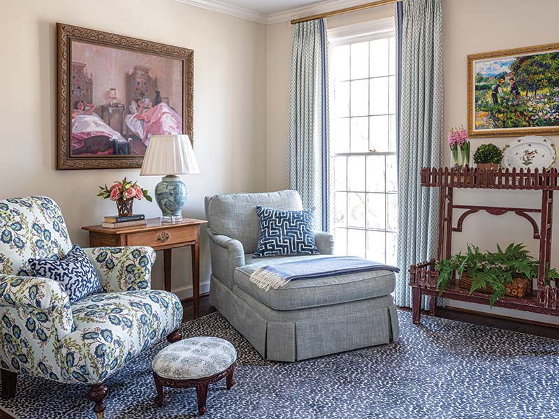 The adjoining sitting room is anchored by the same rug design as in the bedroom, which helps to visually tie the spaces together.