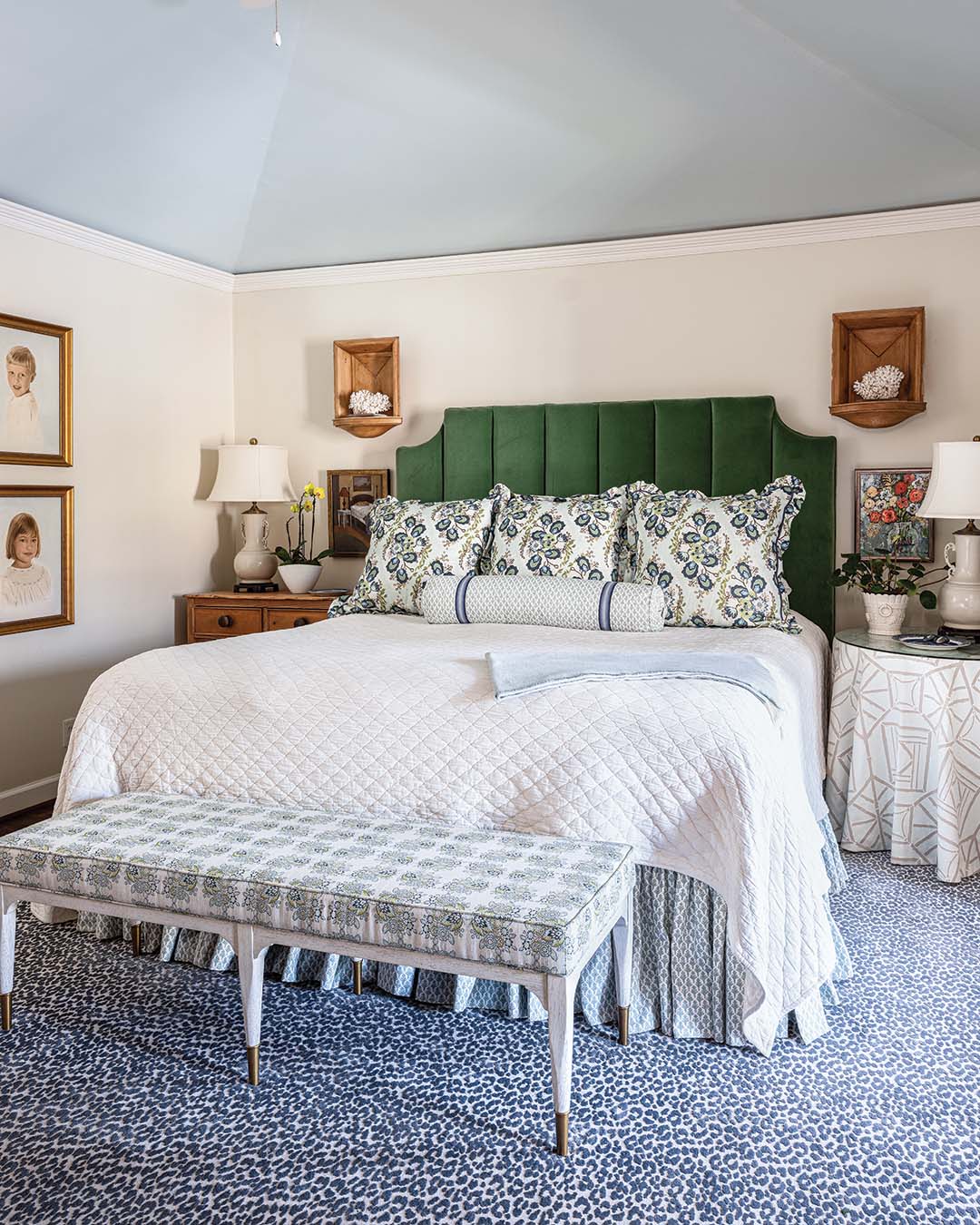 Upstairs, the primary bedroom boasts another thoughtful blend of old and new. The green velvet headboard and Ferrick Mason floral print fabric on the shams were the starting points for updating this tranquil retreat.