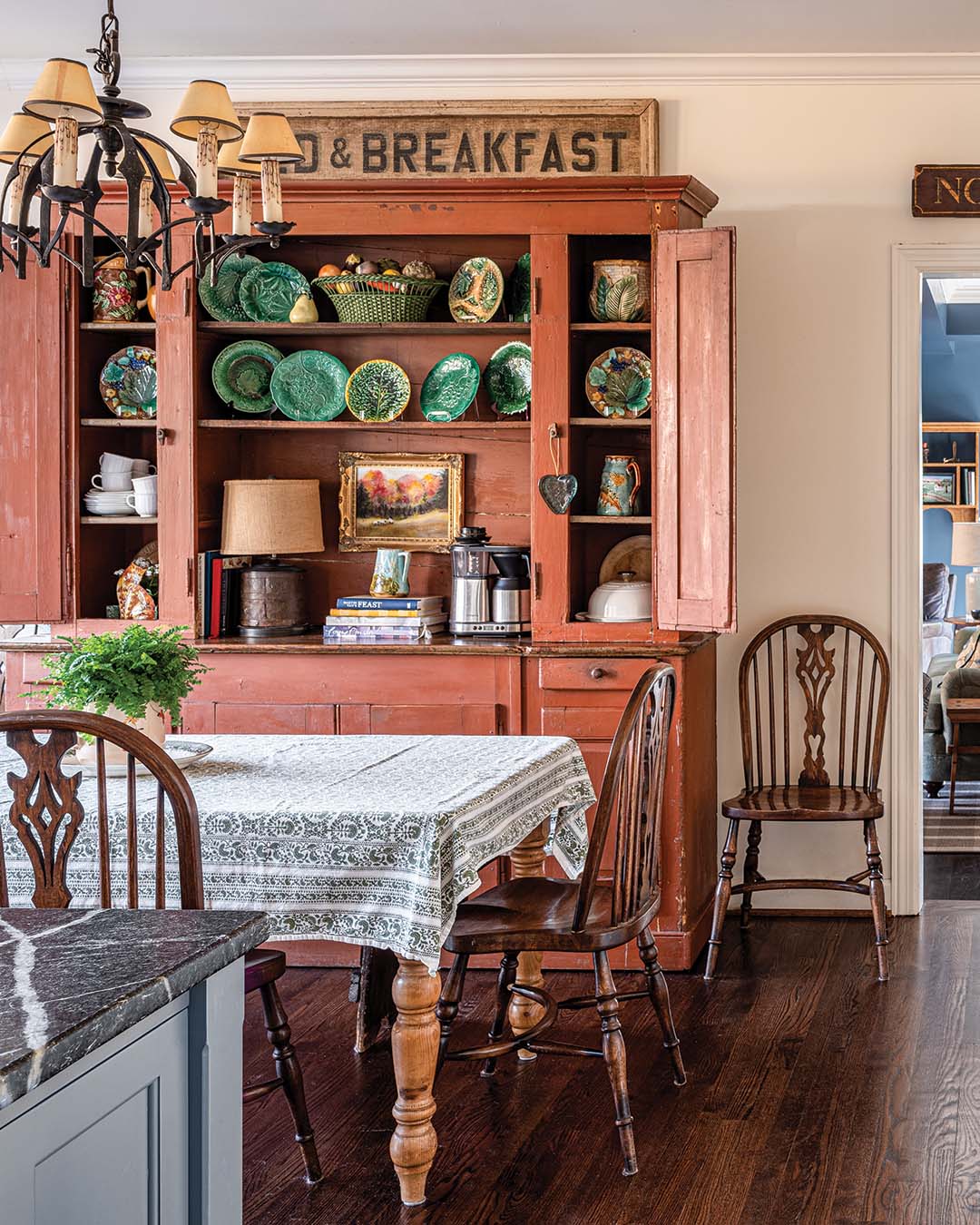 The eat-in dining area is anchored by a red-painted cabinet the family has had for ages. “It’s from the early 1900s, and we think it might have been designed for a store,” Anna says of the hutch. “It’s huge!”