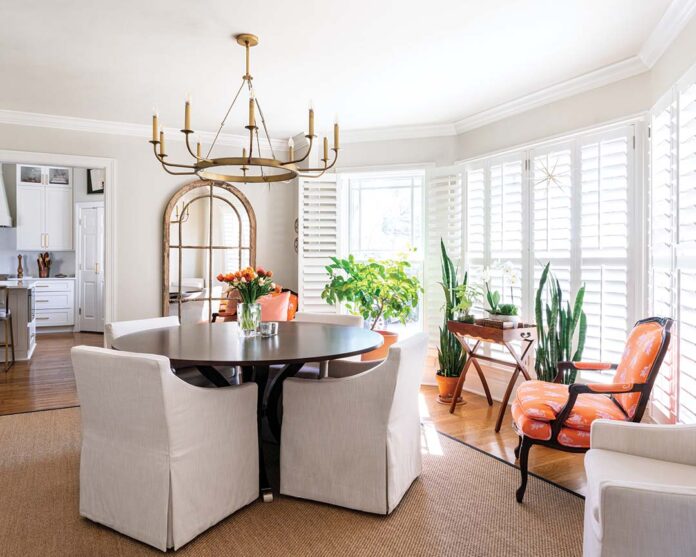 In the dining room, Jessica used a similar method with a classically neutral base and a seemingly unexpected—but carefully calculated—pop of color imbued through an orange-and-pink Lilly Pulitzer fabric on chairs that belonged to Frannie’s mom.