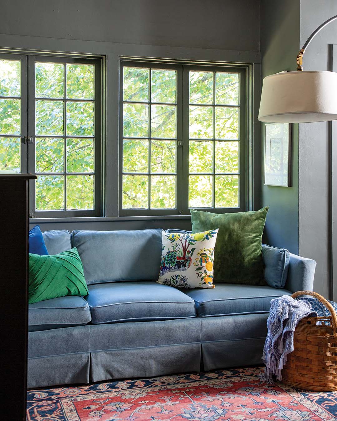 In the dining alcove, the view fits in beautifully with the rich hue of Farrow & Ball’s Green Smoke.