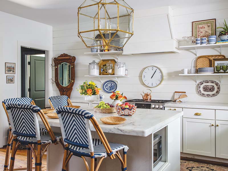 The kitchen features extra-thick marble countertops and a shiplap backsplash perfect for displaying collected treasures.