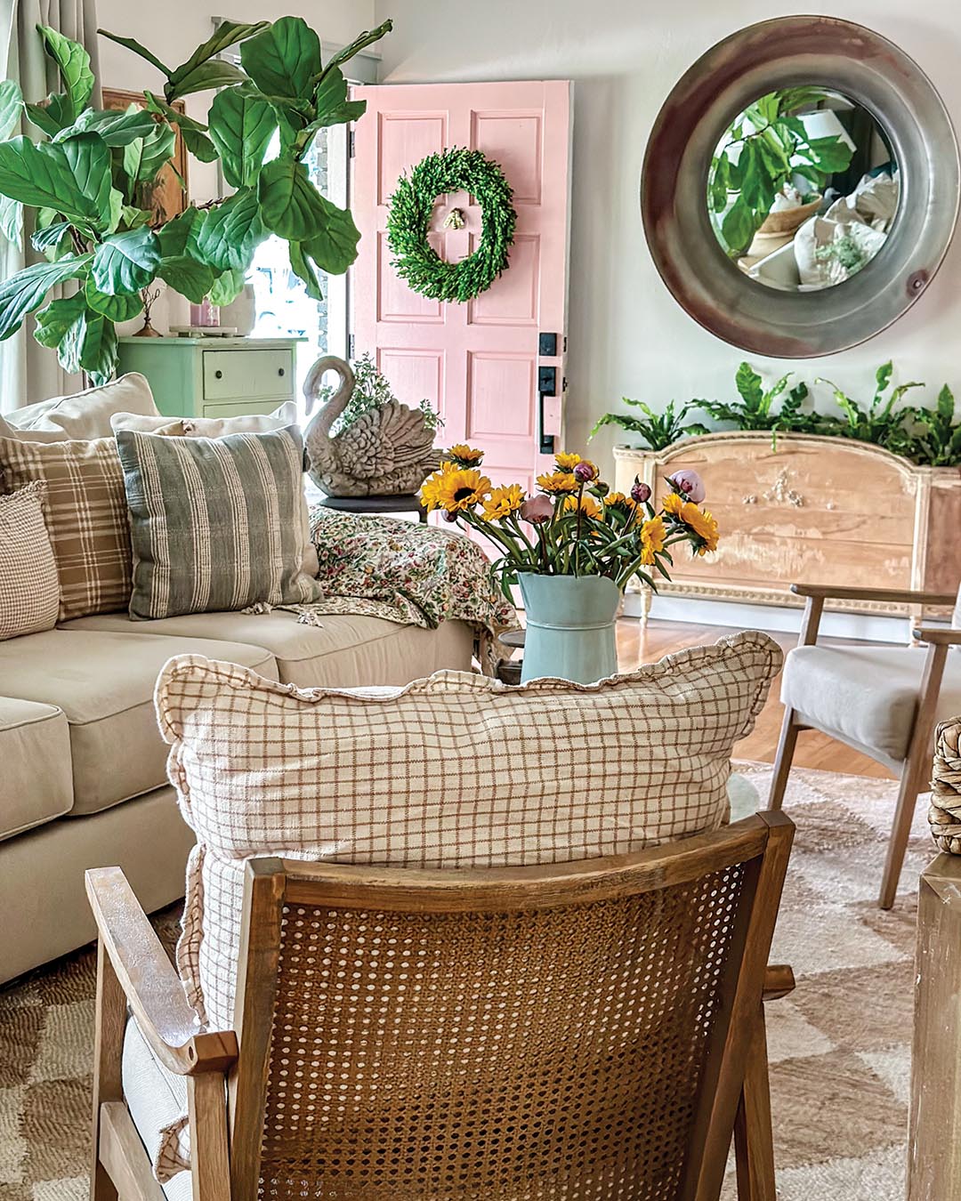 Natural woods pair with neutral upholstery in the living room to provide a versatile backdrop that supports seasonal shifts in decorative accessories. Blankets, throw pillows, and fresh flowers can all be easily changed and lend both comfort and color to the space.