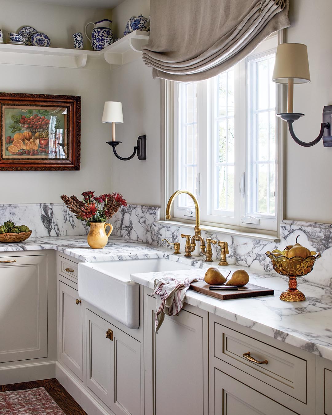 A 1980s kitchen is simultaneously given a contemporary face-lift and a more historic feel with a classic French-country foundation, sleek upgrades, and collected antique accents layered in.