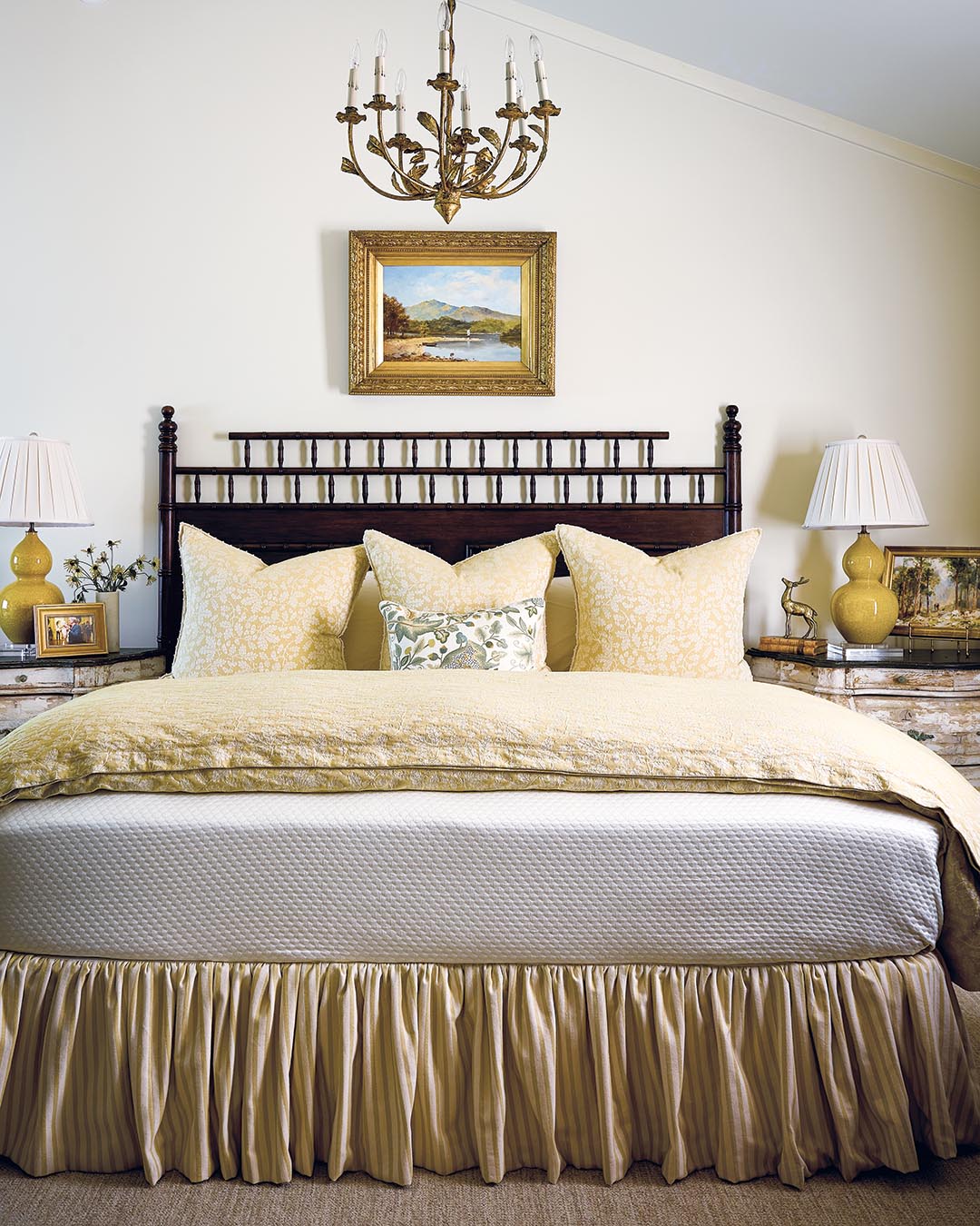 The design of the primary bedroom took its cues from the embroidered Chelsea Textiles fabric used for the bed’s lumber pillow. For the bedding, Debbie used Busatti fabric, noting, “They use the same weaving technique they’ve used since 1847, so [the fabrics have] a lot of texture.” A small crochet trim around the Euro shams is a fi nishing detail that further plays into the old-world charm Debbie wanted.