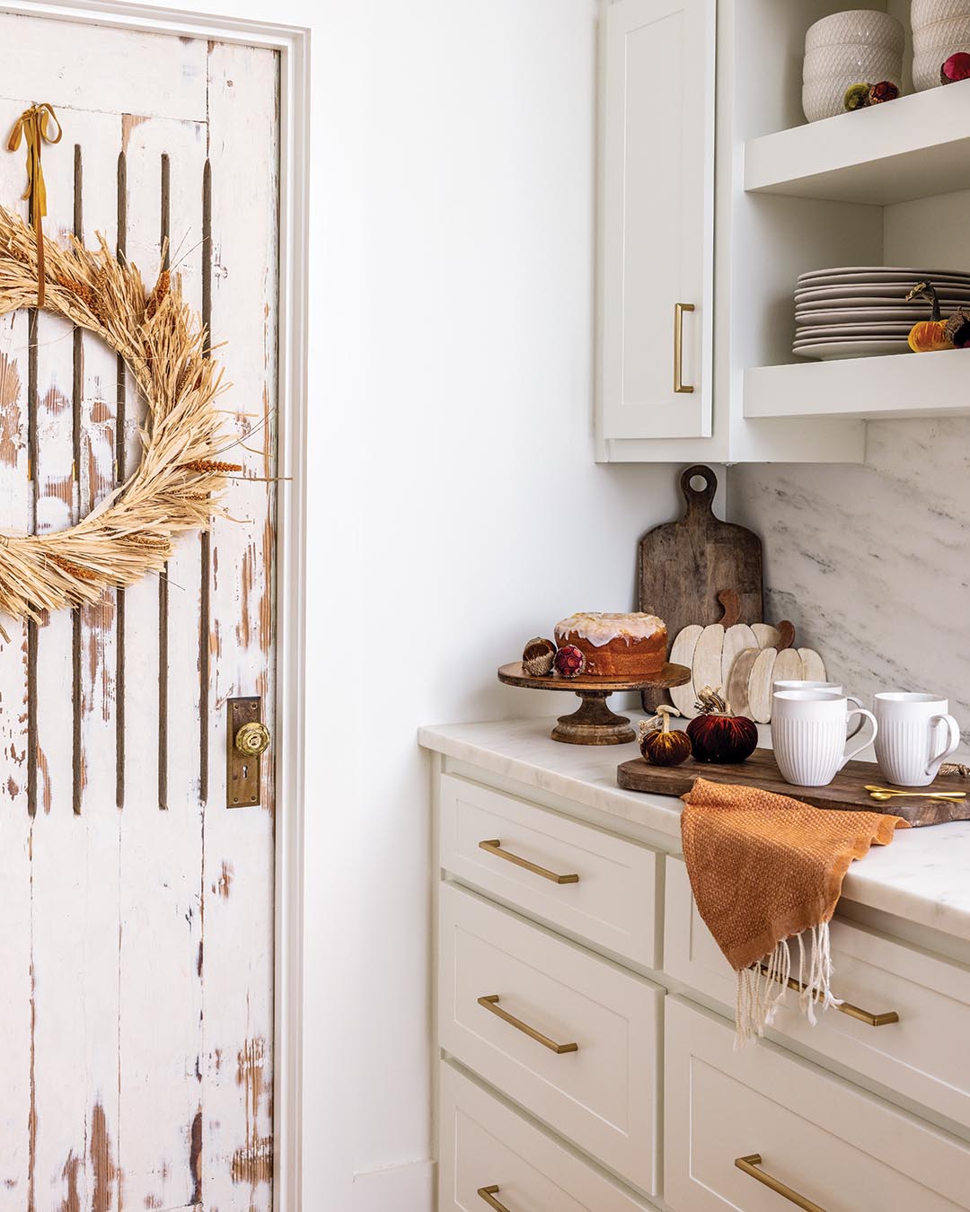 To achieve the light and airy aesthetic, every surface was coated in Greek Villa by Sherwin-Williams. Mixing up the paint finishes ensured there would be a slight variation of the hue for a tone-on-tone look that would still lend depth. White marble with subtle veining tops both the island and the surround before continuing as the backsplash.