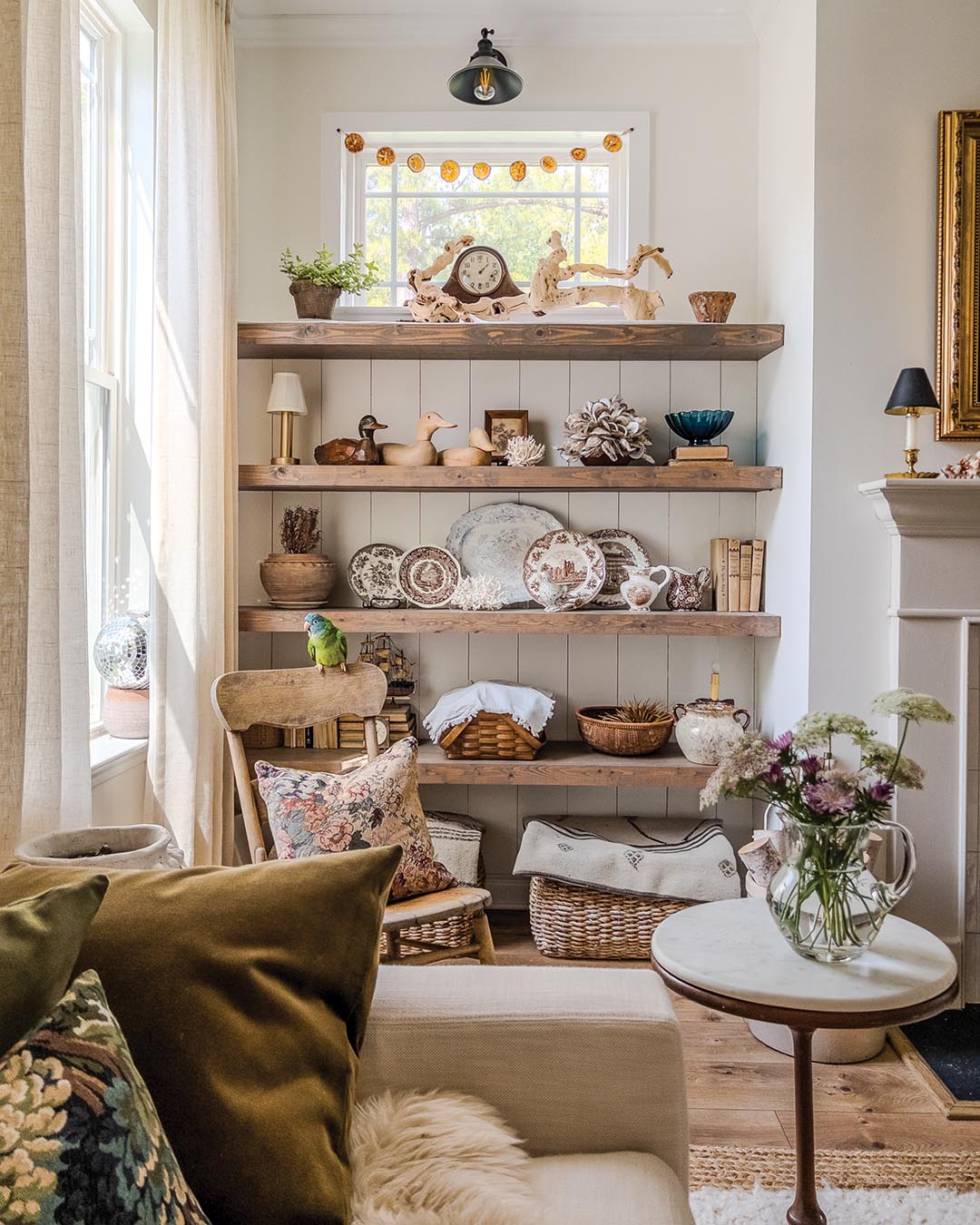 Flanking the fireplace are small nooks that Emi outfitted with floating shelves ideal for showcasing her favorite pieces.