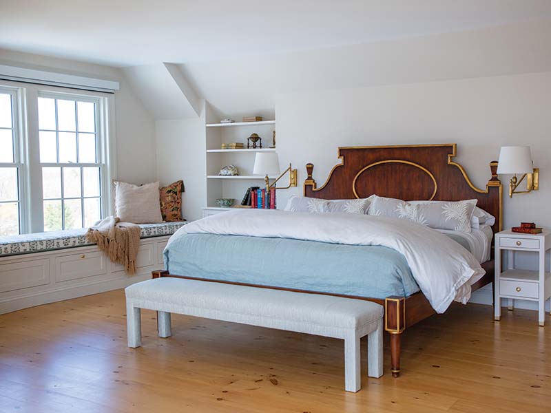 Juxtaposing modern elements and antiques, the primary suite’s large size doesn’t restrict its serenity. Rather, Nicole says she designed cozy zones throughout the space, such as the window seat, a modern chaise, and a mohair Danish banana sofa.