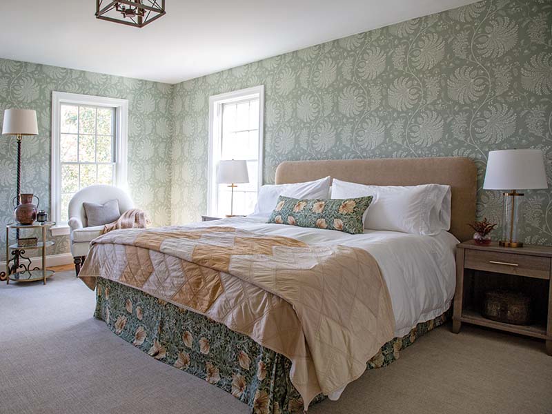 In the guest suite, sweeps of rust, sage, and cream tie in beautifully with the rest of the home, leading to an elevated and classic room that seems anything but an afterthought.