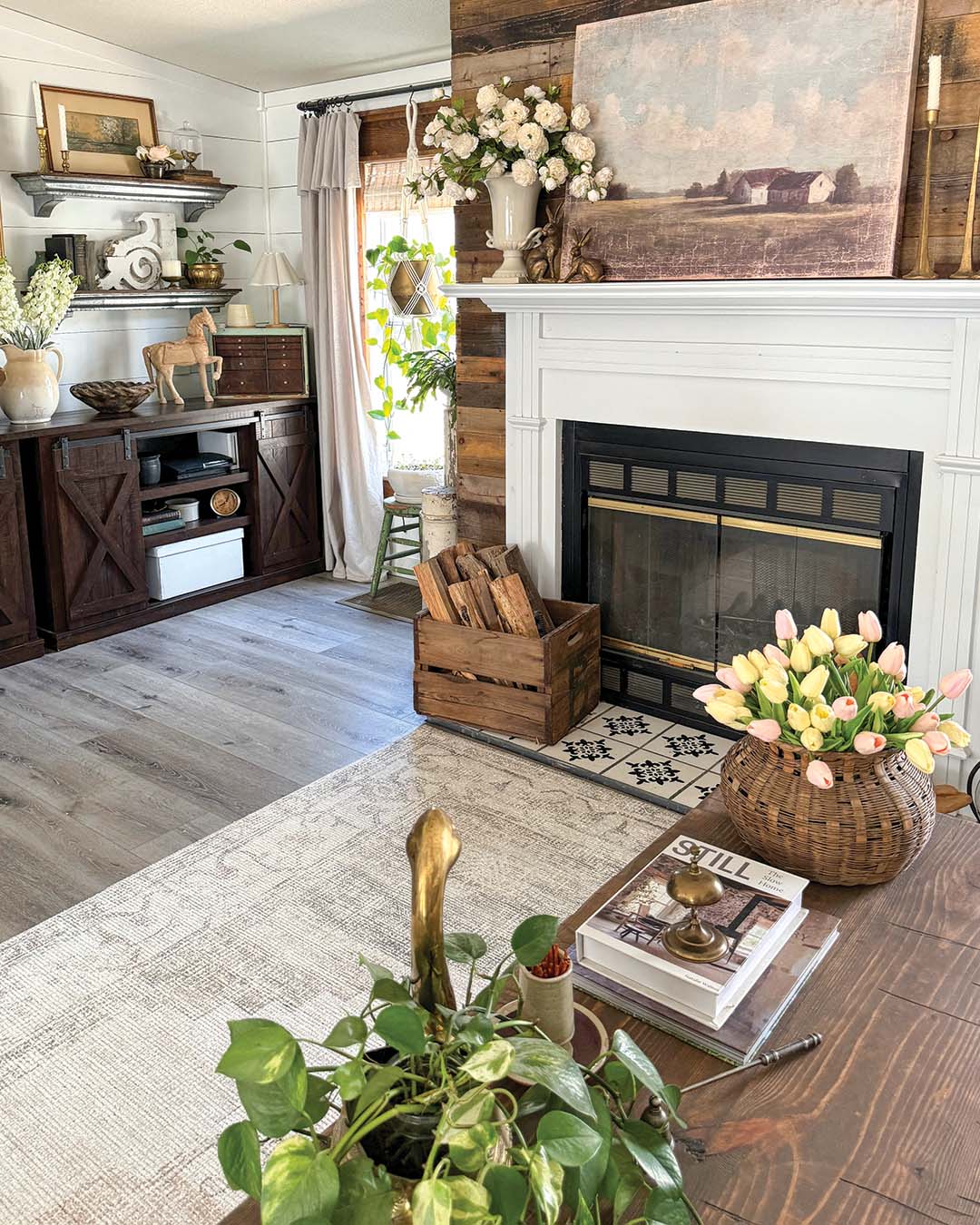 Throughout the cottage, white shiplap walls set a fresh backdrop that allows the storied wood pieces to take center stage. The living room emphasizes that contrast with an accent wall behind the fireplace Kassie created using pallet wood.