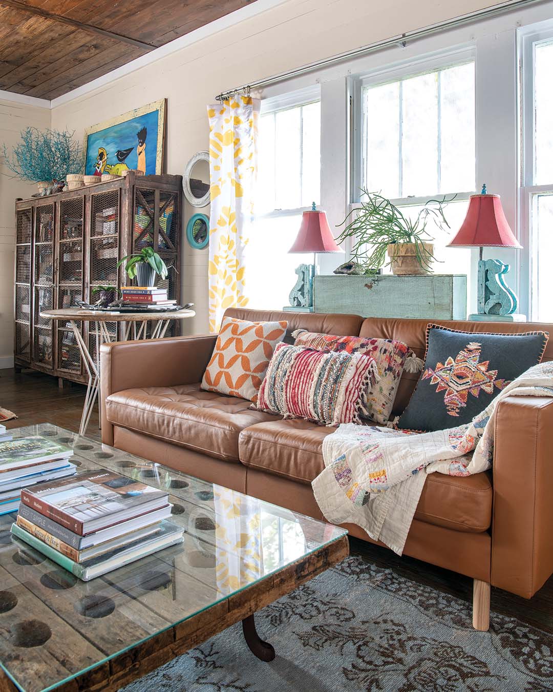 In the same space, an antique French Champagne rack mounted on the base of a potbellied stove provides a place for the couple to display their coffee-table books, and a European piece that might have once been a pie cabinet holds more of their book collection.