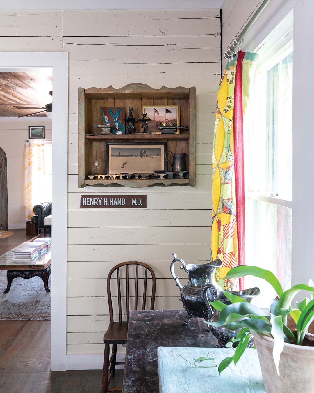 Meredith’s favorite pieces in the home include collections curated by her late father, like the grouping of jeweler’s anvils in the dining room. The pieces are displayed on a hanging shelf pulled from an adobe in Santa Fe, New Mexico, under which hangs a handpainted sign from the office where her father opened his private practice.