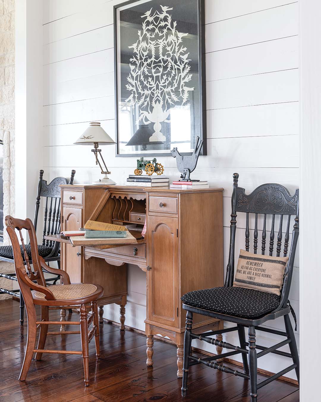 The ladies scoured flea markets and consignment shops to find pieces to accompany the heirlooms throughout—such as the desk in the living room, which belonged to both Peggy’s grandmother and mother and which holds her grandparents’ farm records. Among the favorite finds are the French workbench behind the sofa and the antique toy tractor that sits on top, brought home from a trip to France.