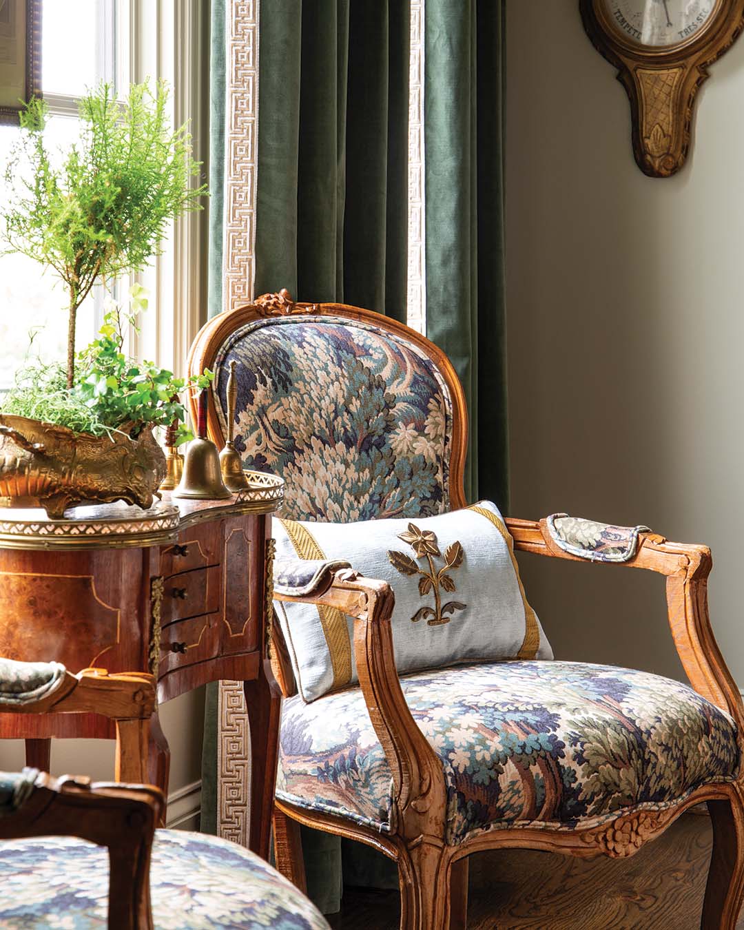 The armchairs by the window enhance this theme as rich wood furnishings impart warmth.