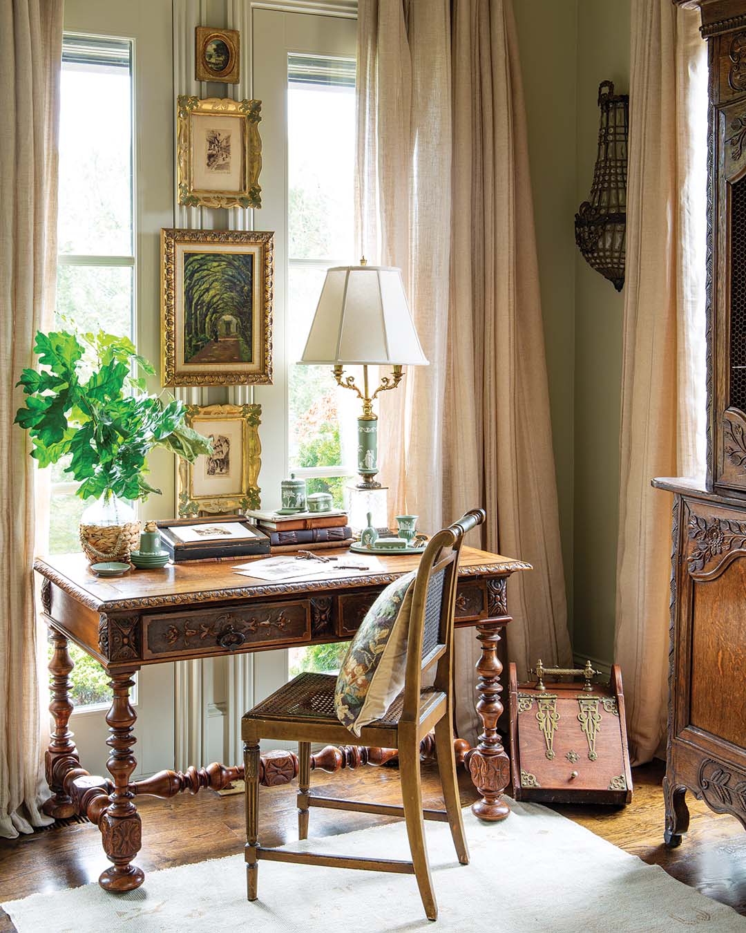 In the study, Florentine frames housing French prints accompany English Wedgwood in a matching green hue, cultivating an overall design that exudes European elegance.