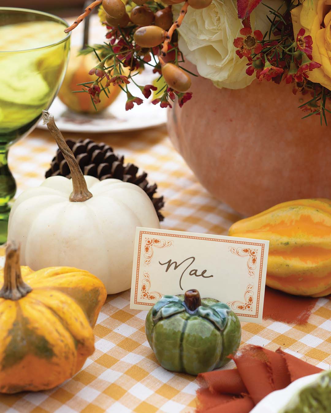 Add a personal touch to the display with hand-addressed place cards, complete with a seasonal gourd-shaped card holder that is sure to make any guest feel right at home.