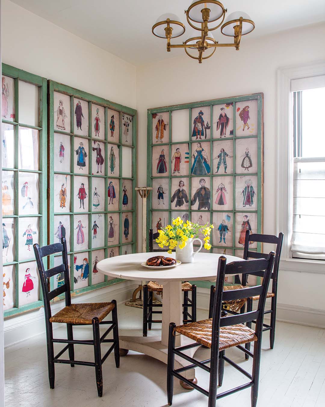 In a stroke of serendipity, Anthony was able to use a set of antique windows he’d been keeping in his basement to create a one-of-a-kind moment in the kitchen’s breakfast area. Featuring copies of pages from a costume illustrator’s book he found at a flea market, the finished product is a showstopping work of art that makes mealtime a fanciful affair.