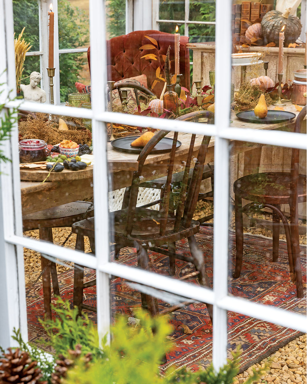 With the structure complete, she says, the goal was for it to be “one with the landscape.” To achieve this, Ashley blurs the lines between the manmade and the natural with foraged foliage and an expert hand, building swags and arrangements on the exterior from scratch. The effect is perhaps most enchanting in autumn, when sunset oranges and canary yellows burst from arrangements over the antique doors that lead the way to even more natural wonders.