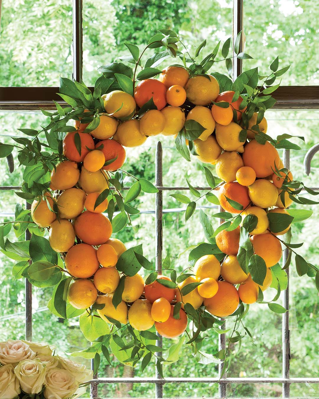 Clusters of lemons, oranges, and kumquats amid airy lime-green foliage offer a bright note against any window.