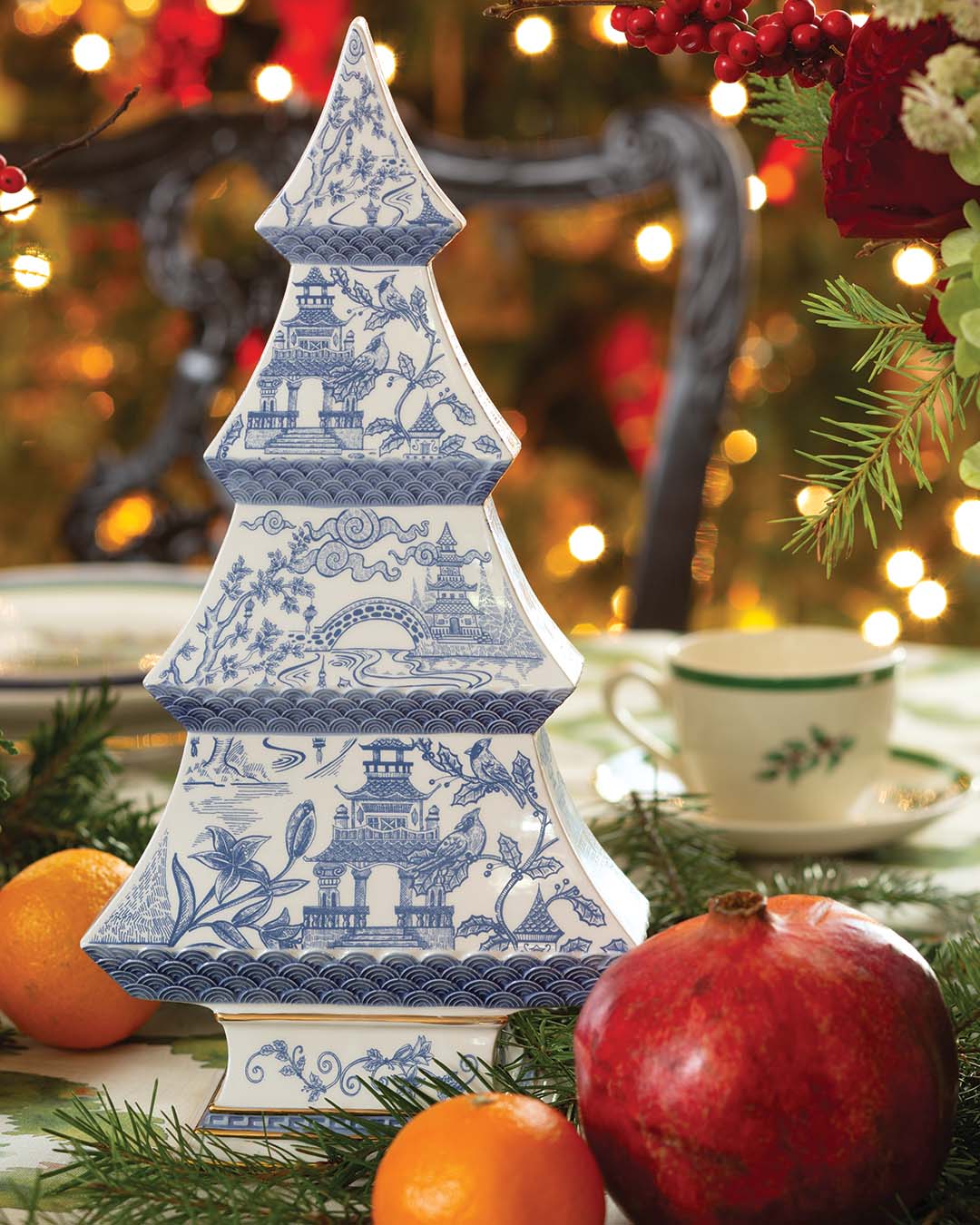 Combining charm with modern accents, beloved blue-and-white china offers grace and ageless elegance to the setting. Spilling out from the floral arrangements, fresh oranges and pomegranates line the table, the vivid hues adding texture and contrast to the scene.