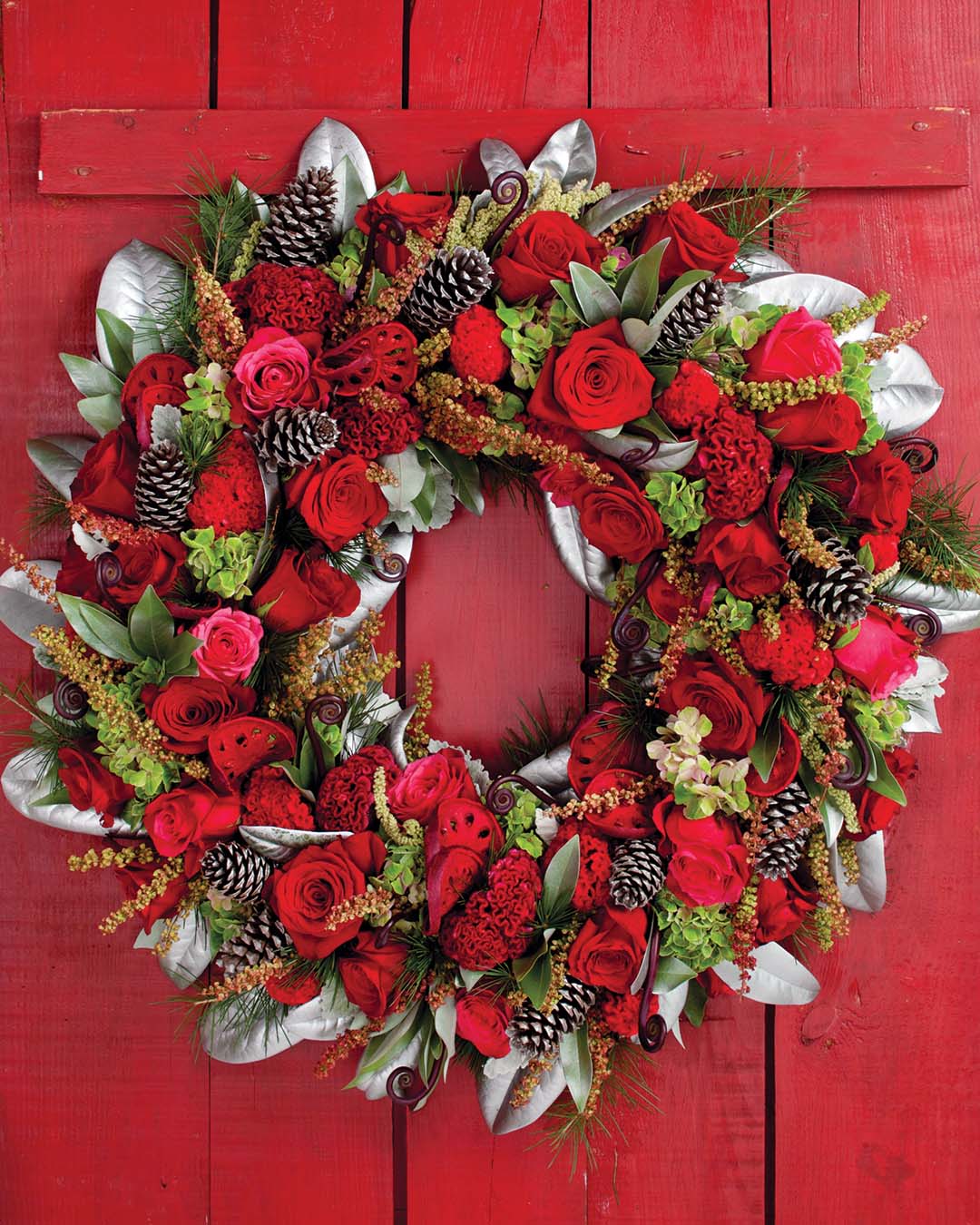 Ready a cozy bedroom for beloved guests with a wreath displayed on a rustic headboard, reflecting the embroidered circlets gracing a duo of seasonal pillows.
