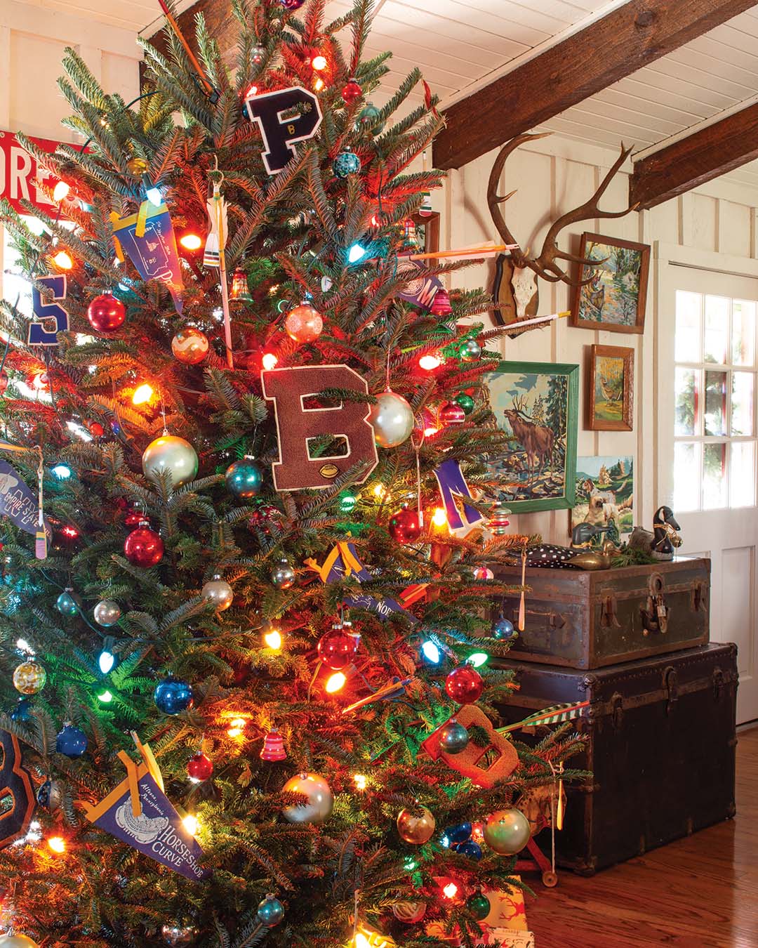 The Christmas tree boasts strands of multicolored bulbs, as it, too, plays host to cherished collectibles.