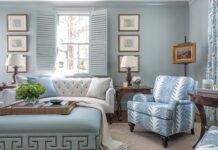 Storied Charm Abounds in This Comfortable Georgia Cottage Virginia notes that the paint used in the TV room is a popular shade, as its undertones allow it to lean blue or green. For this room, the decision to go with blue-on-blue led to a striking space that still boasts the comfort desired by the homeowner. A Peter Fasano fabric dressing the windows includes the various shades seen throughout, from the lounge chairs to the ottoman, tying the room together for a restful, finished effect.