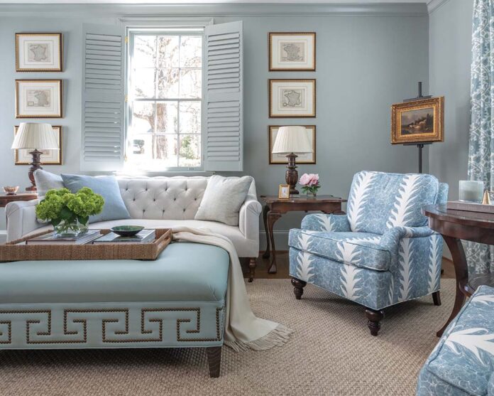 Virginia notes that the paint used in the TV room is a popular shade, as its undertones allow it to lean blue or green. For this room, the decision to go with blue-on-blue led to a striking space that still boasts the comfort desired by the homeowner. A Peter Fasano fabric dressing the windows includes the various shades seen throughout, from the lounge chairs to the ottoman, tying the room together for a restful, finished effect.