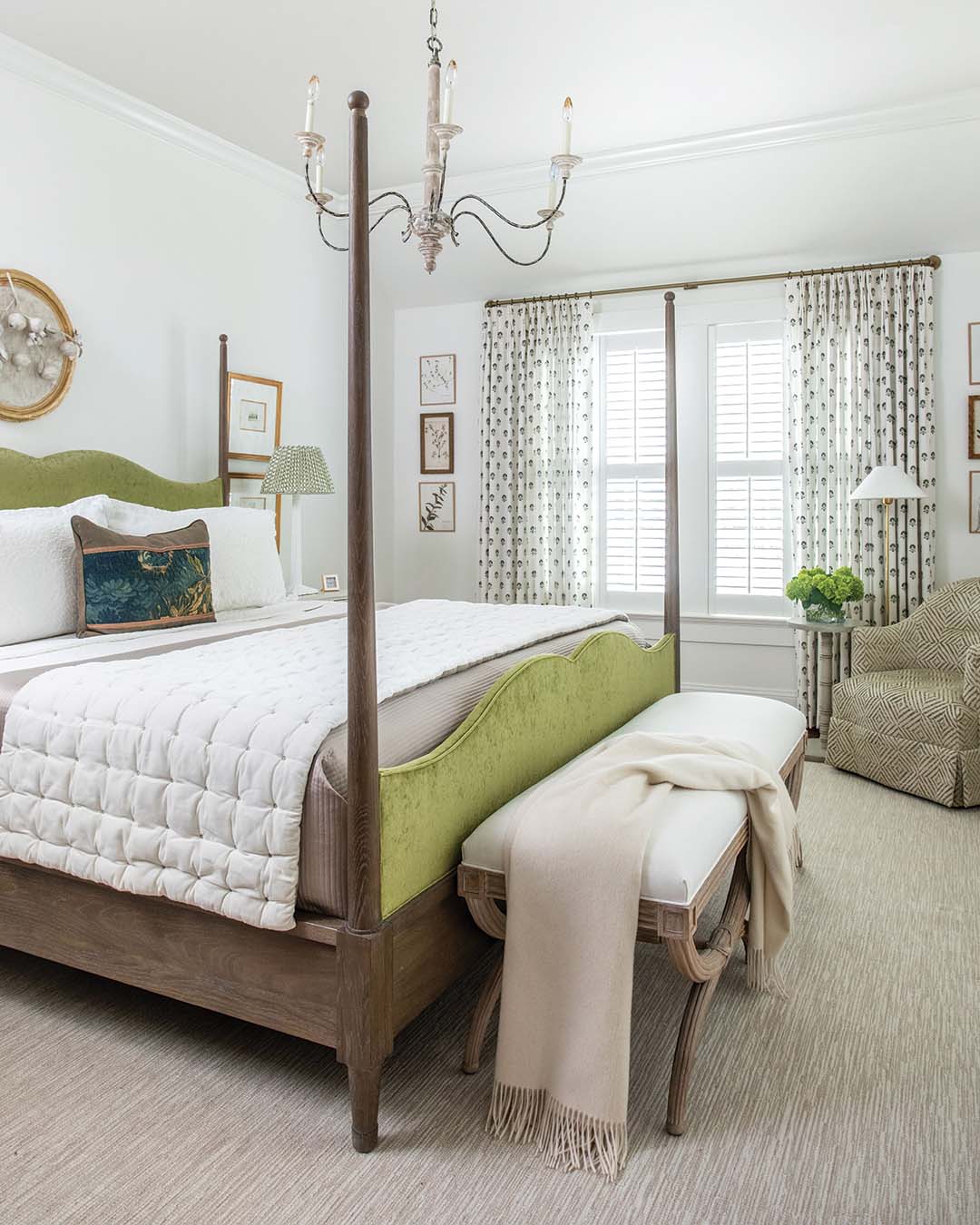 While sky blue shades can be found all around the home, the homeowner’s other favorite hue makes its debut in the primary bedroom. A block-print fabric used to dress the windows was the starting point for the design of the space, atop which Virginia layered various fabrics and patterns in shades of green. “[We] kind of leaned into that mossy green that we upholstered the bed in,” Virginia says. Woven among soothing whites and soft neutrals, the color is both warm and restful, making it the ideal spot for the homeowners to unwind.
