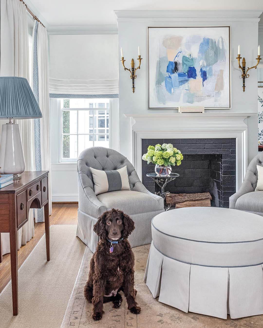The artwork over the fireplace, a piece by Atlanta artist Renée Bouchon, was one of the first things the homeowner bought. “All the fabric selections were kind of based on that work,” Virginia notes.