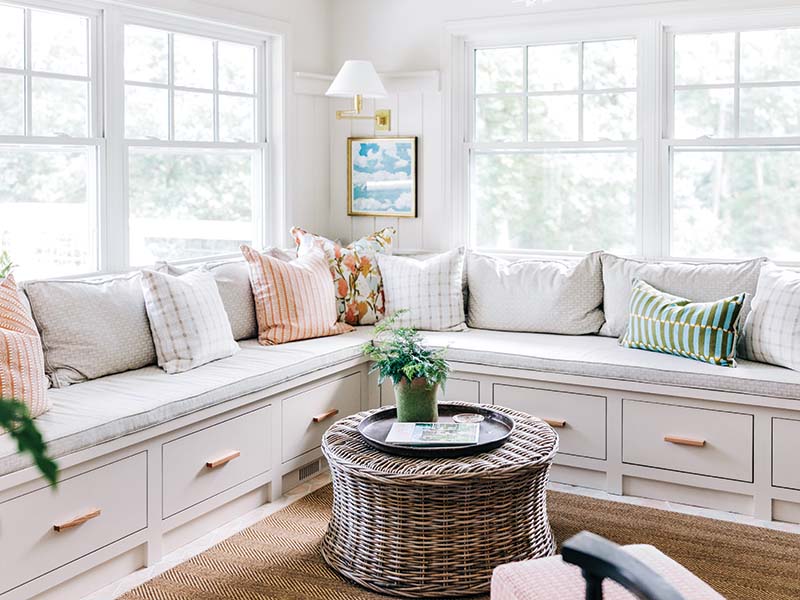 “This room is a prime example of starting with a neutral base and layering in big personality on top,” Amanda Louise says of the keeping room. The custom corner banquette is topped with neutral cushions as well as some of the team’s favorite textile designers, Molly Mahon and Greenville local Teresa Roche. “The vintage mirror sourced from Chairish and the wicker table from Wilson Girls [in Greenville] may be our favorite vignette of the whole house,” she says.