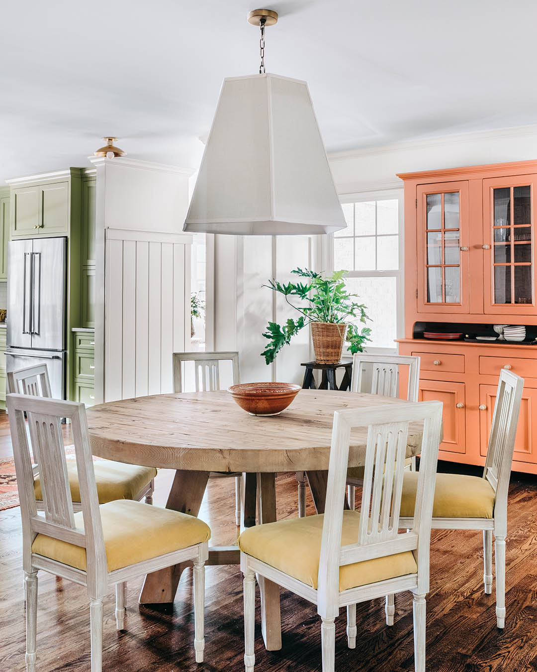 The designer snagged the adorable dining room hutch for the homeowners from Facebook Marketplace and painted it in Benjamin Moore’s Golden Cherry before adding a wallpaper backing for extra texture.