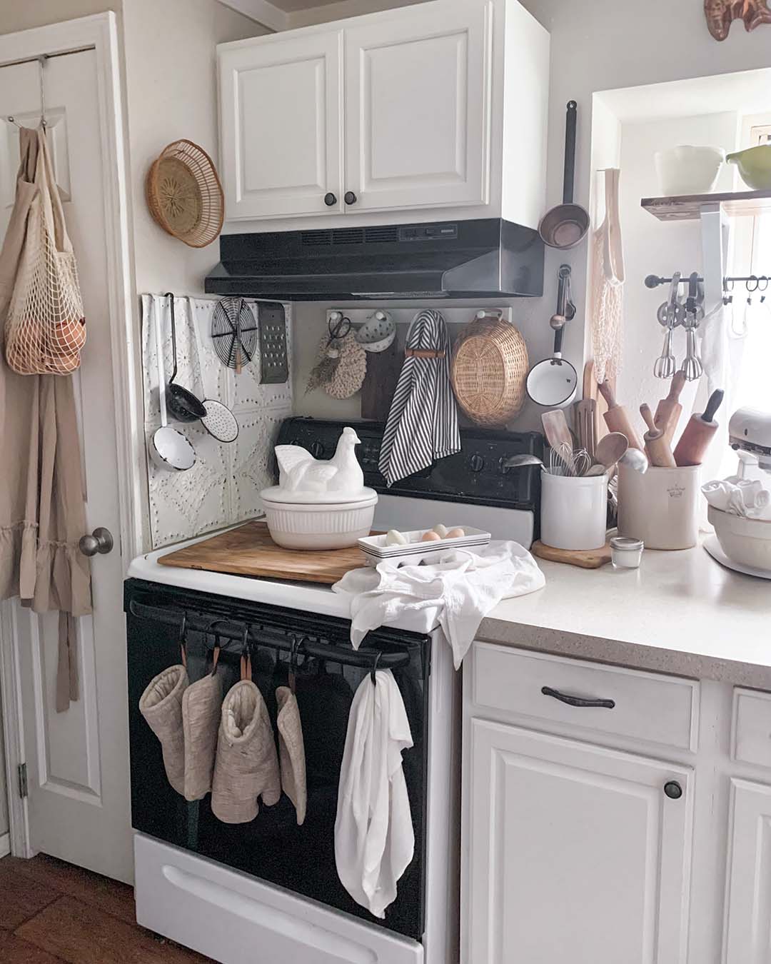 The bright, neutral kitchen design allows Becca’s various collections to shine. “I am a sucker for old, vintage kitchen items. I have a lot, and in order to achieve a cohesive look and not just a look of random clutter, I’ve really had to become a layering master,” she says.
