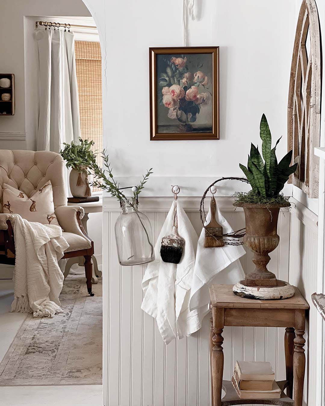 This design approach, fueled by Mickie’s creative spirit, is clear upon entrance. “Since we really don’t have a foyer, I created an illusion of one,” she says of the small space she spruced up with beaded board, a peg rail, and an ideally sized vintage pine table, as well as a medley of neutral accents and artwork.