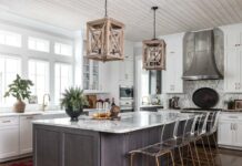 Tour a Transitional Home Layered with Mid-Century Style & Antique Finds Meg pulled from the whitewashed wood of the lanterns when selecting the woven and wood accessories dotted about the space. An antique tole tray draws the eye to the range as it lends a dark contrast to the marble tile backsplash.