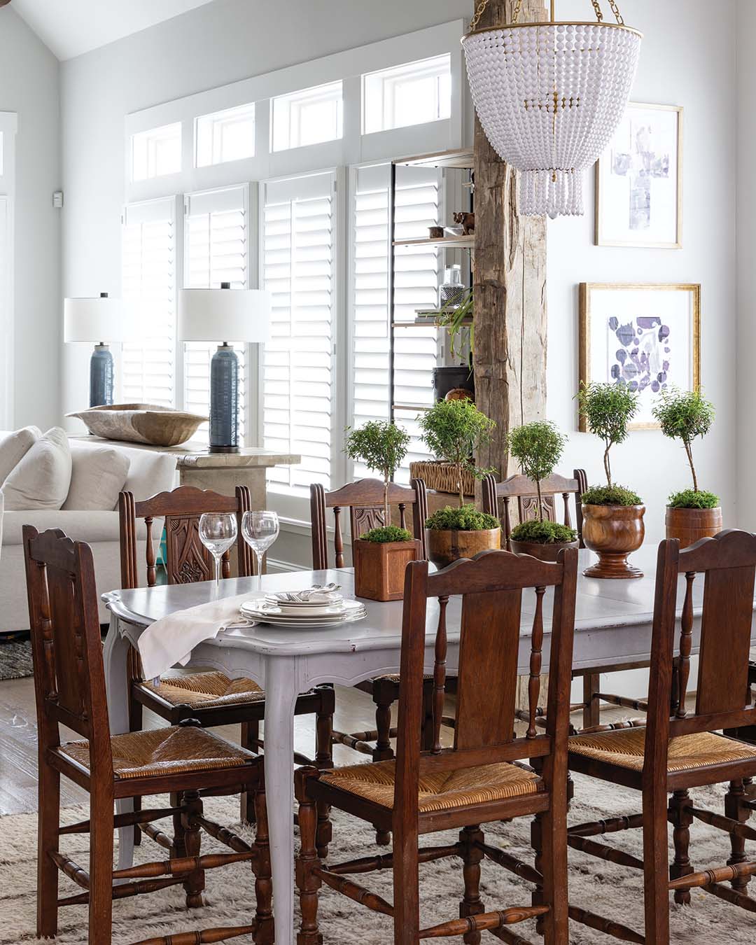 Handed down from the homeowner’s grandmother, an heirloom dining table and china cabinet anchor the eating area. “I love the mix of the really traditional chairs with the more abstract rug,” says Meg. “It just flows well into the more contemporary space in the back and keeps the design interesting.”