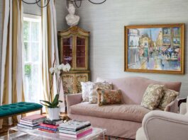 This Southern Home Puts a Unique Spin on Classic European Charm Velvet sofas and acrylic tables pair perfectly with an antique painted hutch in the living room.
